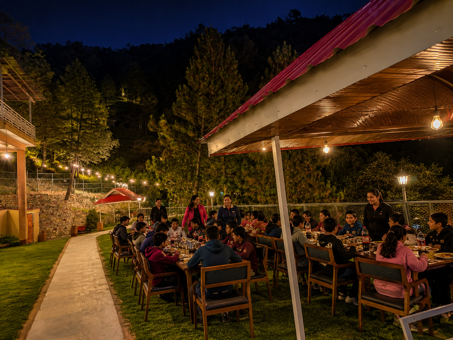 School students having dinner on the resort lawn
